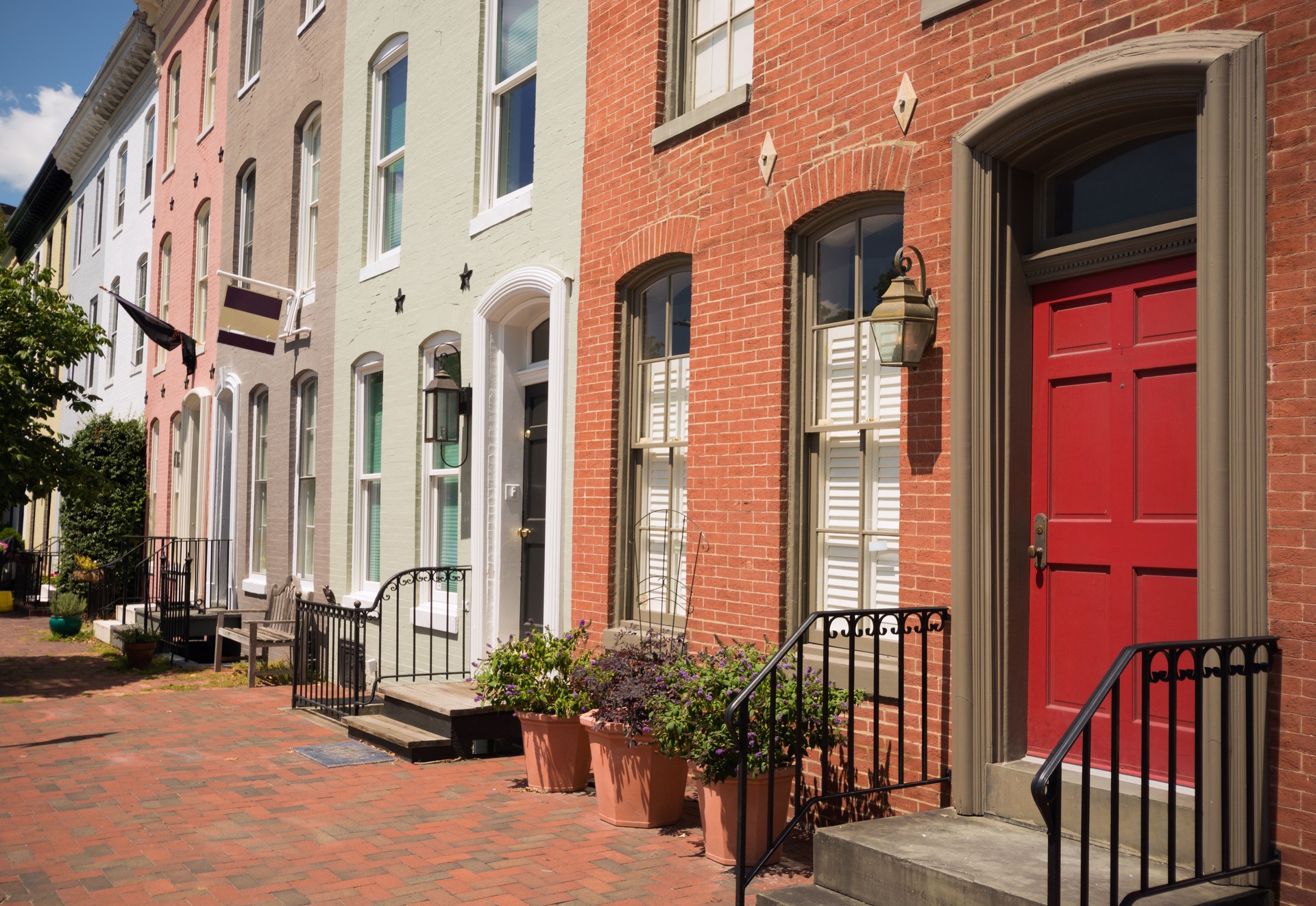 Row of brick houses on a residential street in Baltimore, MD